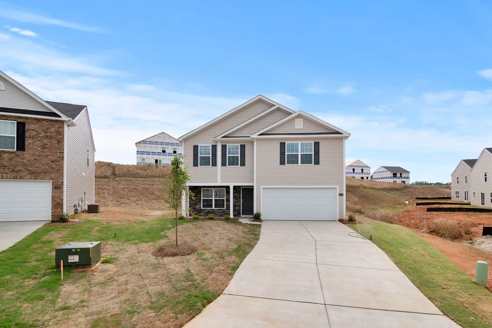 Concrete driveway leading to a suburban house